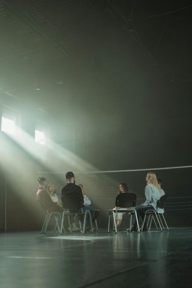 A group of students sitting in a circle doing group work